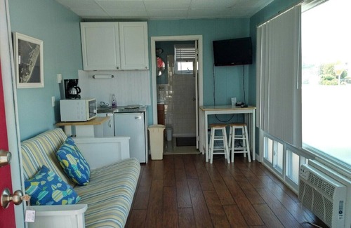 Stone Harbor Condo | 1st Floor Front Efficiency Unit, right side, corner Tables and chairs in the court yard.