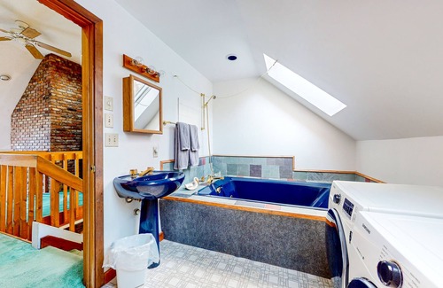 Jamaica Condo | 2-story mountain condo with fireplace, private deck, WFH setup, & jetted tub
