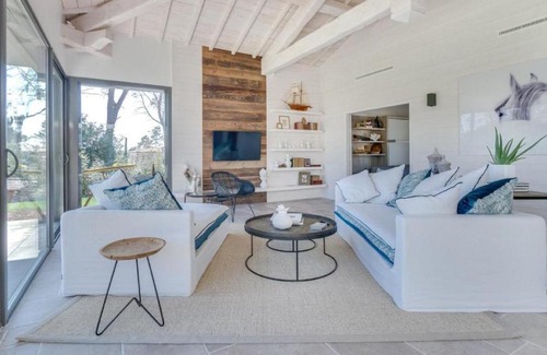 Magalas Apartment | A large table with chairs and a garden furniture with sunbeds