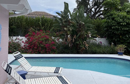 Central Beach House | A tropical retro bungalow secluded area with terrazzo flooring & heated pool.