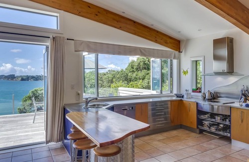 Oneroa House | Absolute Beachfront - Oneroa Bay - Enjoy gazing over Oneroa Beach from this impressive 2-story, 3-bedroom holiday house with a Spanish-inspired theme. Accommodating 8 guests who will all enjoy sitting directly beach front. Providing luxurious accommo