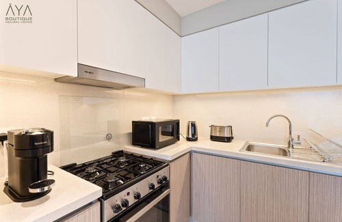 Dubai Apartment | Aya - Elegant 1BR Apartment With Balcony and Creek Views