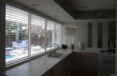 Imperial Point House | Backyard Paradise: 2bd/2bath Waterfront Home, Heated Salt Water Pool, Tiki Bar