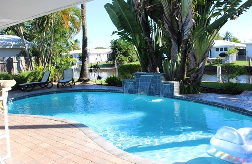 Imperial Point House | Backyard Paradise: 2bd/2bath Waterfront Home, Heated Salt Water Pool, Tiki Bar