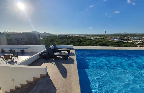 El Tezal Apartment | Beach Bliss Retreat, Renovated Condo with Rooftop Pool, Grill, and Game Night Vibes!