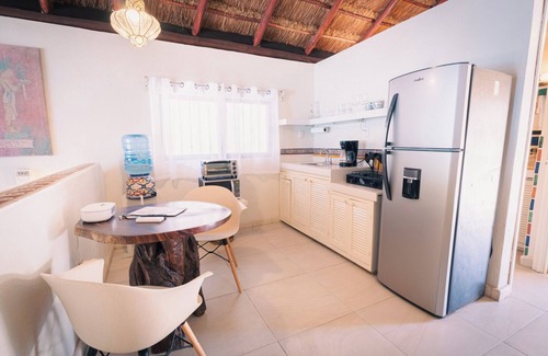 Isla Mujeres Cottage | Beachfront palapa cottage with heated pool , sunsets and tropical gardens