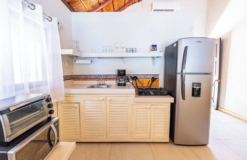 Isla Mujeres Cottage | Beachfront palapa cottage with heated pool , sunsets and tropical gardens