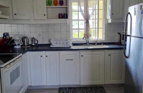 Marine Gardens Condo | Beautiful Condo with breezy Balcony Overlooking Pool & Garden – Steps to Beach