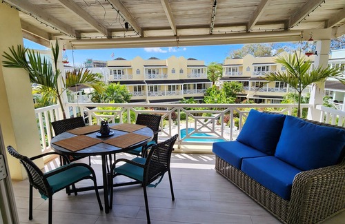 Marine Gardens Condo | Beautiful Condo with breezy Balcony Overlooking Pool & Garden – Steps to Beach