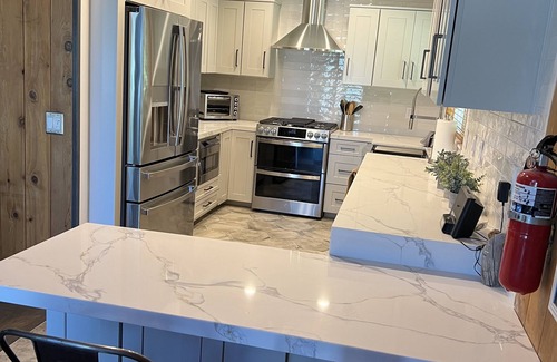 Blue Jay Cabin | Beautiful updated 3 level home with high ceilings, a wall of windows & game room