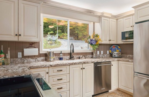 Muskoka Lakes Cottage | Beautifully landscaped with a sandy beach, outdoor sauna, hot-tub and ample water toys.