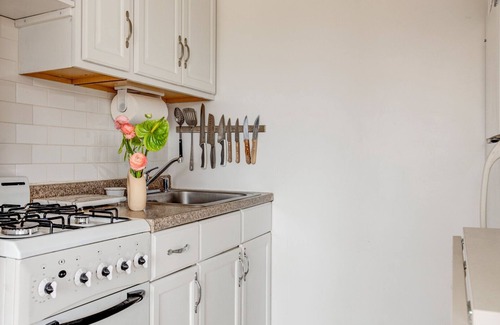 Montauk House | Bohemian-style hotel unit with ample natural light, a cozy seating area,.
