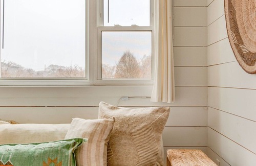 Montauk House | Bohemian-style hotel unit with ample natural light, a cozy seating area,.