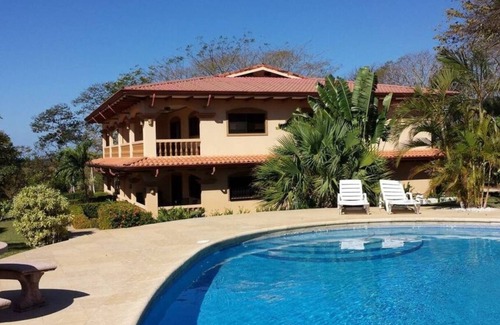 Junquillal Condo | Bright 2BR, 2BA condo with A/C, pool, fast Wi-Fi, and garden-view balcony. Walk to Playa Junquillal.