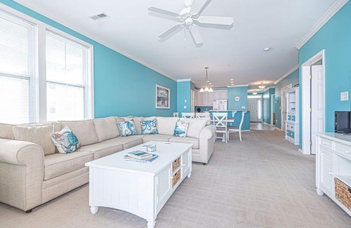 Sunset Island Condo | Bright, modern 3-bedroom luxury condo in gated community, free WiFi, private bayside beaches, an indoor and outdoor pool, and more located midtown and a couple blocks to the ocean!