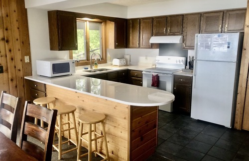 Suttons Bay House | Cabin-style home near Suttons Bay. West Bay beachfront. Fireplace. Central AC