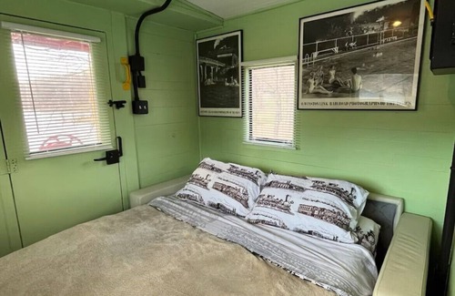 Freedom Bed & Breakfast | Charming Caboose-turned-tiny home on lake