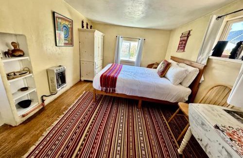 San Cristobal House | Charming Log Cabin Rental on Eco-Farm near Taos Ski Valley
