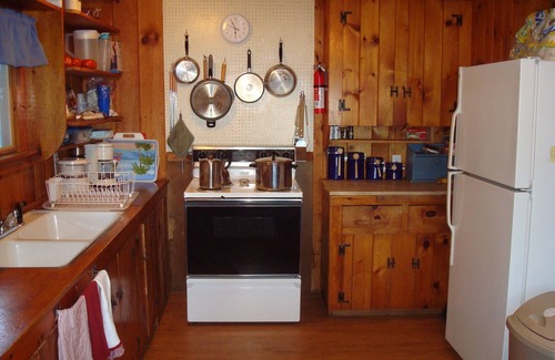 North Sebago Cottage | Classic pine paneled Maine cottage with large sandy beach on Sebago Lake.