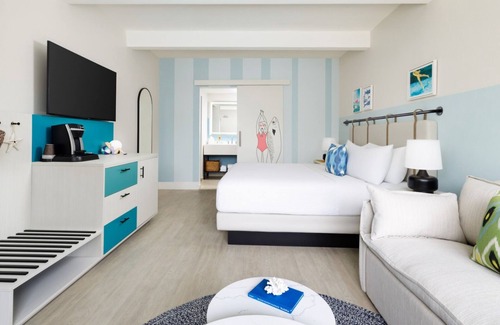 New Town Hotel | Colorful Stay at Blue Flamingo | Poolside Bar, Lawn Games, Music & Fire Pits