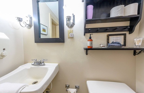 Stowe Bed & Breakfast | Comfortable room with queen bed and daybed with windows on 3 sides, a stunning view of Mount Mansfield and a parlor stove with full service breakfast included