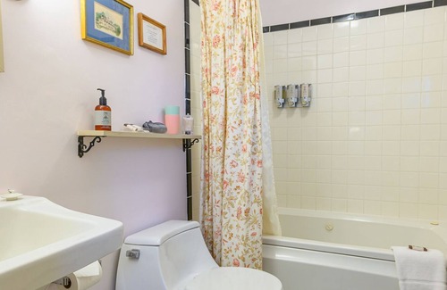 Stowe Bed & Breakfast | Comfortable room with queen bed and twin trundle, a stunning view of Mount Mansfield, sitting area with couch and a parlor stove with full service breakfast included