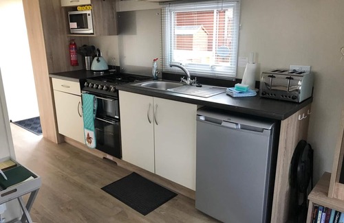 Boat of Garten House | Cosy chalet - Poppy Lodge in Boat of Garten, Dog Friendly, free wifi!