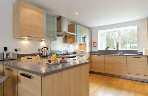 Cirencester House | Cotswolds Lake side home with luxury spa Swallows Nest,Lower Mill Estate, Lakeside home and spa with a Harry Potter cupboard under the stairs