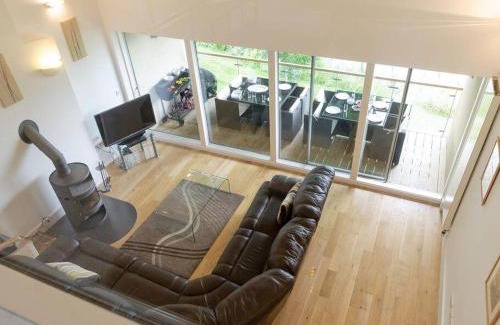 Cirencester House | Cotswolds Lake side home with luxury spa Swallows Nest,Lower Mill Estate, Lakeside home and spa with a Harry Potter cupboard under the stairs