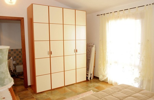 Baia Sant'Anna Apartment | Cottage with beautiful garden, in quiet area