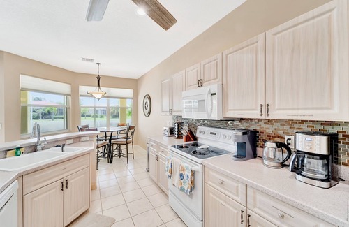 Herons Glen House | Country club retreat with private pool, water views, on-site golf, & gym