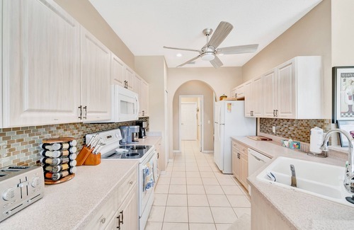 Herons Glen House | Country club retreat with private pool, water views, on-site golf, & gym