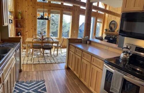Redmond Ski Chalet | Cozy knotty pine chalet with creekside deck, BBQ, and access to pools, hot tubs, gym, golf, hiking.