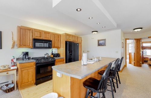 North Troy Condo | Cozy ski-in/ski-out home next to Grammy Jay trail with fireplace, mountain views