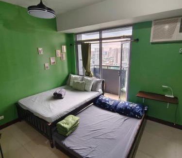 Socorro Apartment | Cubao Manhattan Heights Residential Condo TB30N - High Floor Studio with Balcony City View, Pool, Netflix, 5-Min Walk to the Araneta Coliseum Gateway Mall SM - Staycations by SMS