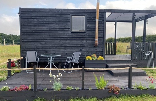 Aldeby Cottage | Curly Cow is a marvellous shepherd’s hut that sleeps up to four people.
