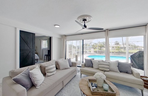 Fort Myers House | Dog-friendly home with private pool, dock, fireplace, patio, grill, & canal view