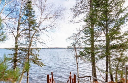 Presque Isle Cabin | Dog-friendly lakefront cabin with on-site swimming, fishing, & rec room