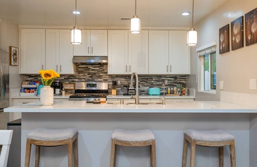 Orange House | Dog-friendly retreat near Disney with enclosed yard, cornhole, central AC, & W/D