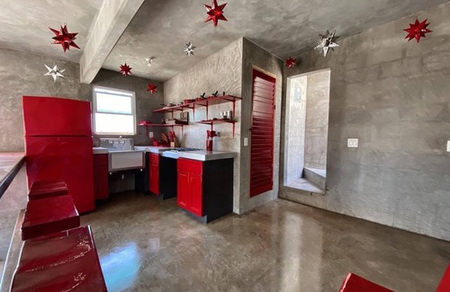 Ensenada Apartment | Eclectic Cliffside Den with Hanging Living Area