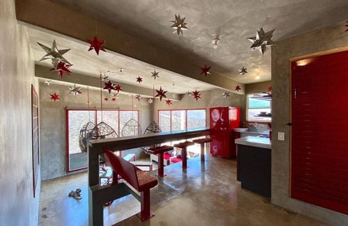 Ensenada Apartment | Eclectic Cliffside Den with Hanging Living Area