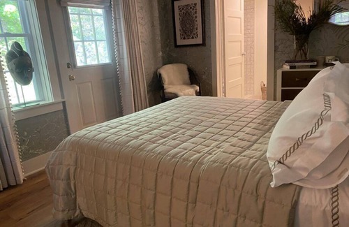 Lenox Bed & Breakfast | Elegant Carriage House room with a queen bed and private patio.