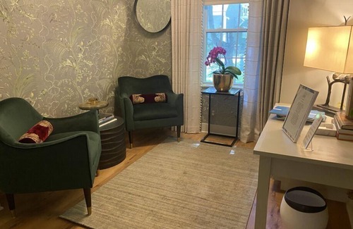 Lenox Bed & Breakfast | Elegant Carriage House room with a queen bed and private patio.