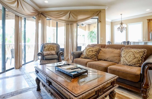 St. Tropez House | Elegant coastal villa with spacious patio, pool, hot tub, free WiFi & central AC