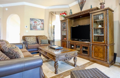 St. Tropez House | Elegant coastal villa with spacious patio, pool, hot tub, free WiFi & central AC