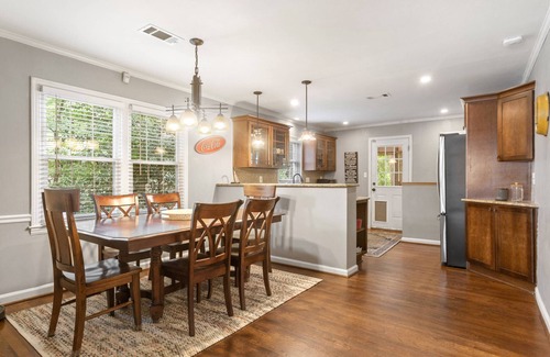 East Side House | Embark on a Grant Park Retreat: Zoo Proximity, Fire Pit Relaxation, and Lion-Sized Dinner Ambience