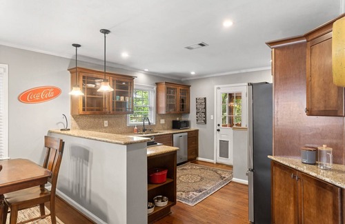 East Side House | Embark on a Grant Park Retreat: Zoo Proximity, Fire Pit Relaxation, and Lion-Sized Dinner Ambience