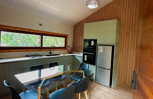 Pucon Cottage | Enarbol Lodge, private hot tube on terrace. High-rise house among trees
