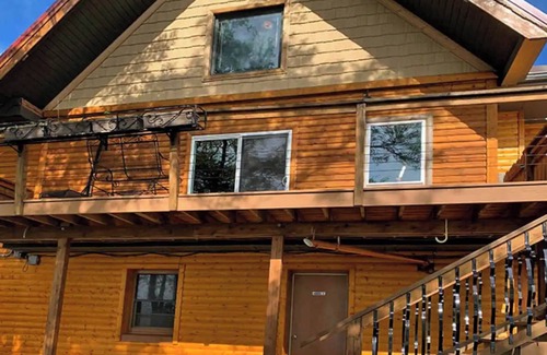 Rice Lake Ski Chalet | Enjoy a quiet stay on your own private deck by the lake in Room 21: Ponderosa-a Western Themed Chalet