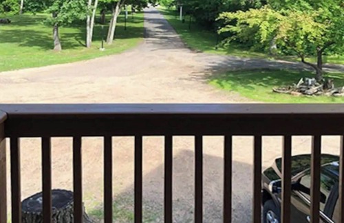 Rice Lake Ski Chalet | Enjoy a quiet stay on your own private deck by the lake in Room 21: Ponderosa-a Western Themed Chalet